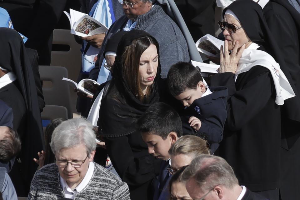 Melissa Villalobos, from Chicago, and her family attend a canonization Mass in St. Peter's Square at the Vatican, Sunday, Oct. 13, 2019. Her healing, which saved her life and the life of her unborn child, was accepted as a miracle to declare John Newman a saint. Pope Francis on Sunday canonized Cardinal John Henry Newman, the 19th-century Anglican convert who became an immensely influential, unifying figure in both the Anglican and Catholic churches. (AP Photo/Alessandra Tarantino)