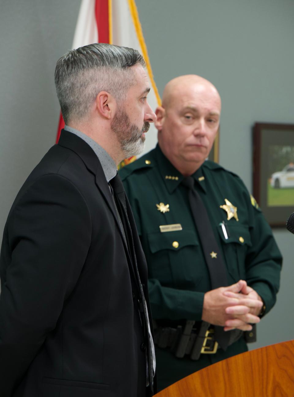 Assistant State Attorney Mark Alderman discusses an arrest as Sheriff Bob Johnson looks on Feb. 5, 2021.