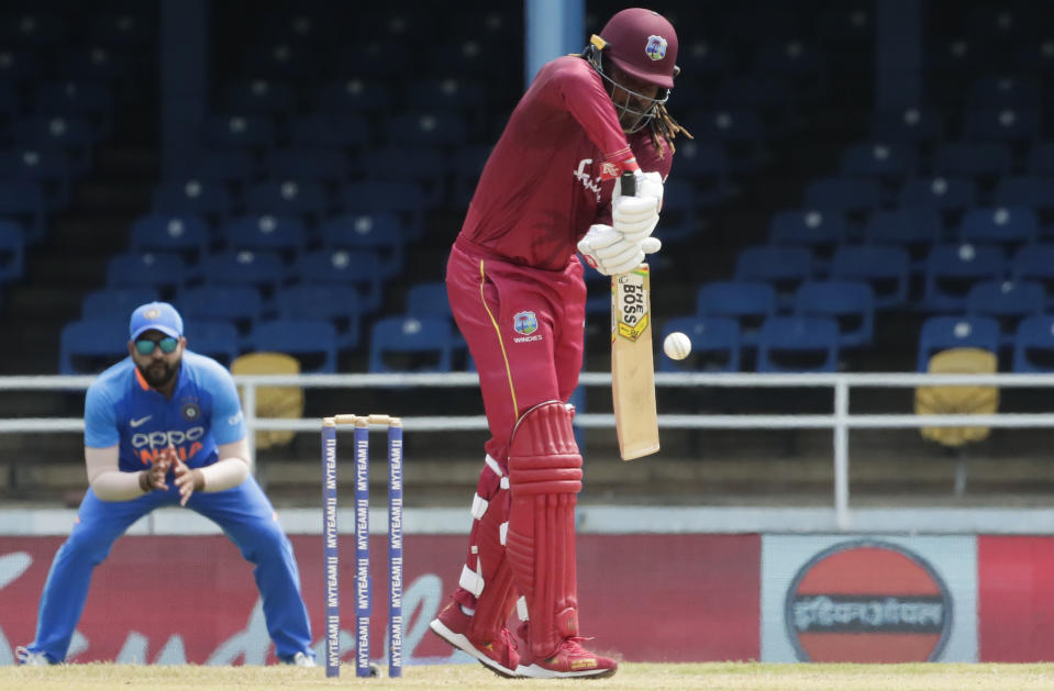 West Indies opening batsman Chris Gayle defends his wicket during the second One-Day International cricket match against India in Port of Spain, Trinidad, Sunday, Aug. 11, 2019. (AP Photo/Arnulfo Franco)