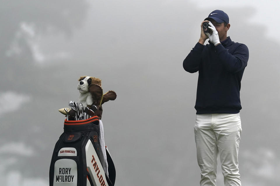 Rory McIlroy, of Northern Ireland, checks the yardage from the third tee during practice for the PGA Championship golf tournament at TPC Harding Park in San Francisco, Tuesday, Aug. 4, 2020. (AP Photo/Jeff Chiu)