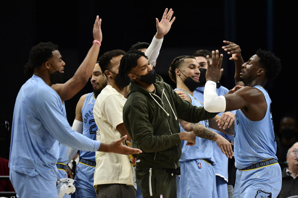 Memphis Grizzlies forward Jaren Jackson Jr., right, greets teammates in the first half of an NBA basketball game against the Oklahoma City Thunder, Thursday, Dec. 2, 2021, in Memphis, Tenn. (AP Photo/Brandon Dill)