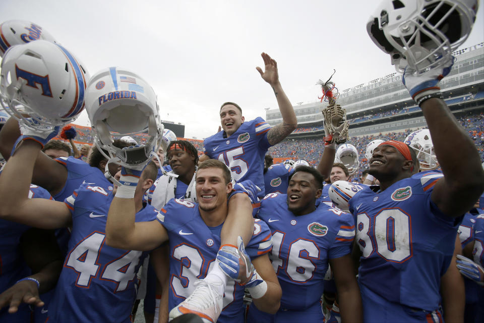 Florida place kicker Eddy Pineiro (15) sits on the shoulders of his teammates as they celebrate after defeating South Carolina 20-7 in an NCAA college football game, Saturday, Nov. 12, 2016, in Gainesville, Fla. Pineiro kicked two field goals in the game, including one for 54-yards. (AP Photo/John Raoux)