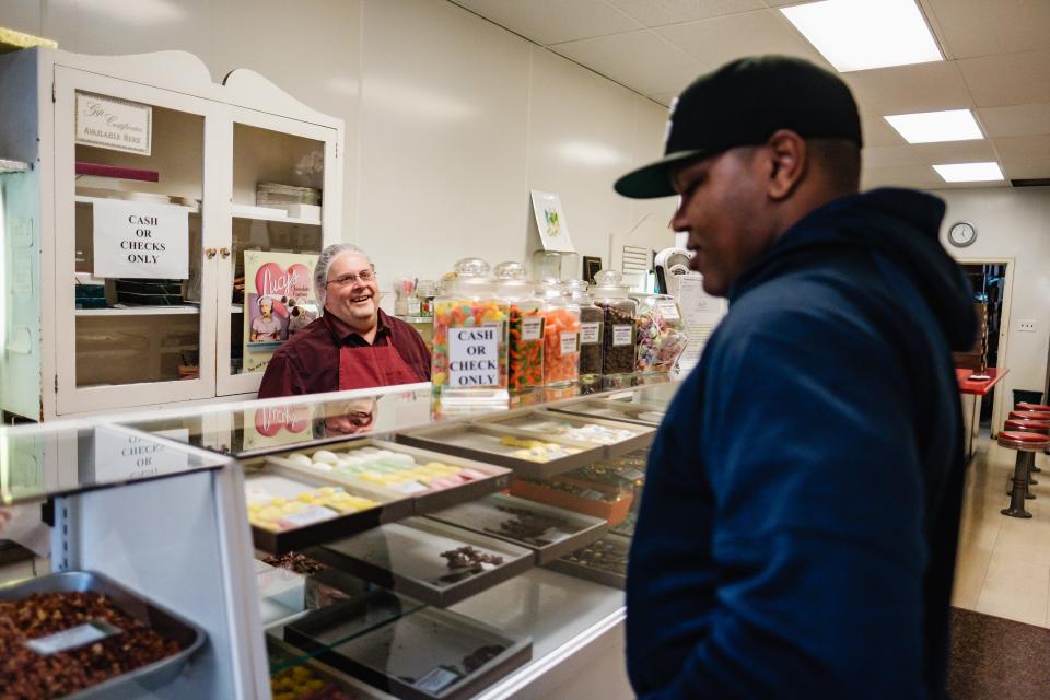 John Gibbs, left, co-owner of Eiler Candy Shop in Dover, chats with Perci Garner III, current city councilman and executive director at the Rainbow Connection. Garner had stopped in to purchase something sweet after leaving the hospital for a routine medical procedure.