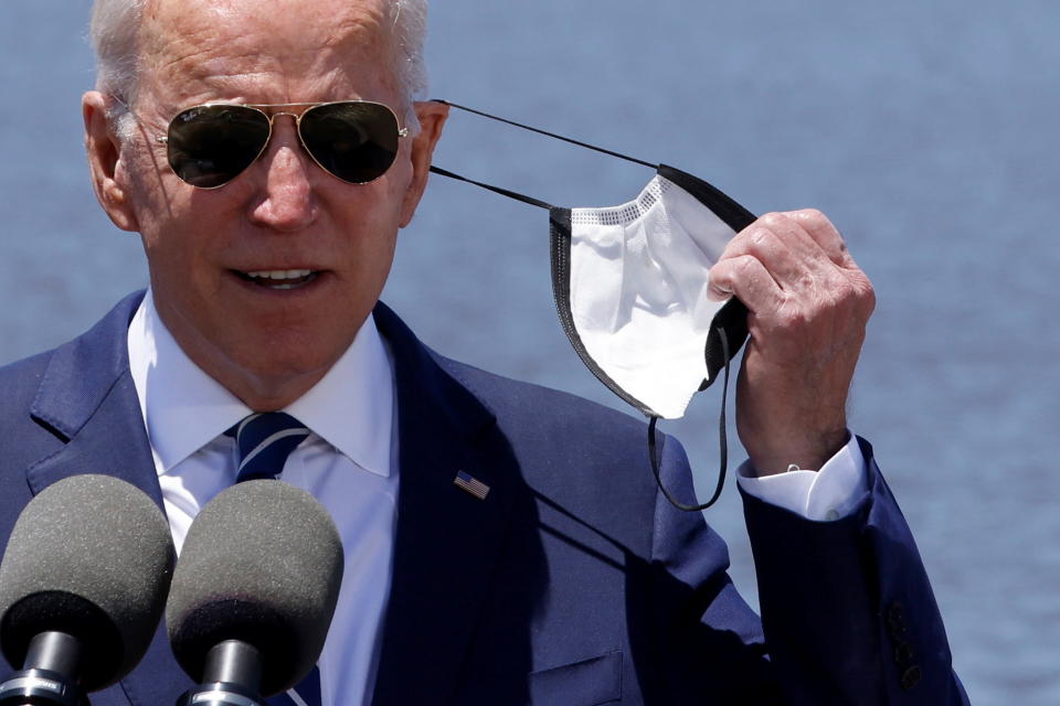 U.S. President Joe Biden removes his protective face mask to deliver remarks on his American Jobs Plan near the Calcasieu River Bridge in Lake Charles, Louisiana, U.S., May 6, 2021.  REUTERS/Jonathan Ernst