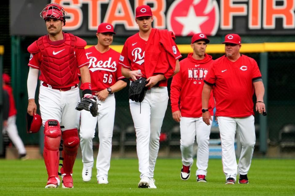 Cincinnati Reds catcher Curt Casali (12), left, and Cincinnati Reds starting pitcher Nick Lodolo (40), center, walk in from the dugout before a baseball game between the Chicago White Sox and the Cincinnati Reds, Saturday, May 6, 2023, at Great American Ball Park in Cincinnati. 