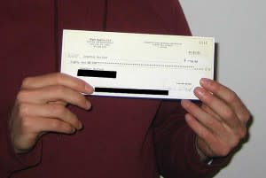 Man holding up a cheque