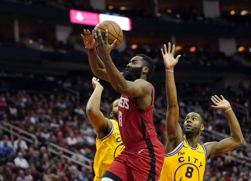 Houston Rockets' James Harden (13) goes up for a shot as Golden State Warriors' Alec Burks (8) and Omari Spellman defend during the second half of an NBA basketball game Wednesday, Nov. 6, 2019, in Houston. The Rockets won 129-112. (AP Photo/David J. Phillip)