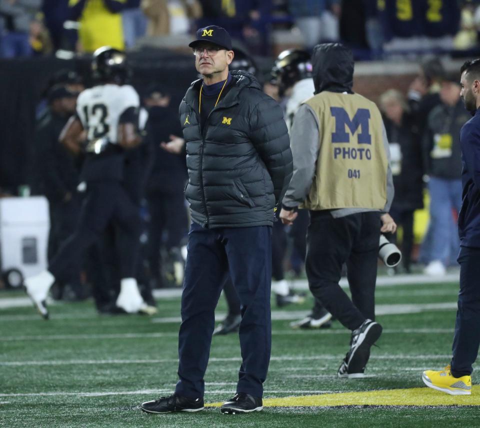 Michigan Wolverines head coach Jim Harbaugh watches his team warm up before action against the Purdue Boilermakers at Michigan Stadium, Saturday, Nov. 4, 2023.