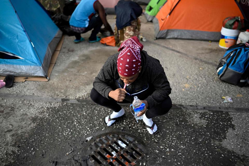 May 18, 2023: A woman traveling with migrant families, mostly from Haiti, brushes her teeth as she waits in a makeshift shelter to receive a permit to continue their journey northward to the Mexico-US border, in Mexico City. Attempted illegal crossings of the southern US border have plunged since new policies to deal with undocumented migrants came into place last week, Blas Nunez-Neto, assistant secretary of the Department of Homeland Security said on May 17. The lifting of Title 42, the COVID-19 health emergency rule used for three years to swiftly expel a wide array of migrants, was lifted on May 11.