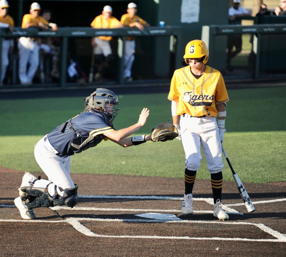 Stephenville's Cutter Gray prepares to catch a popped-up bunt as Snyder's Brandt House watches.