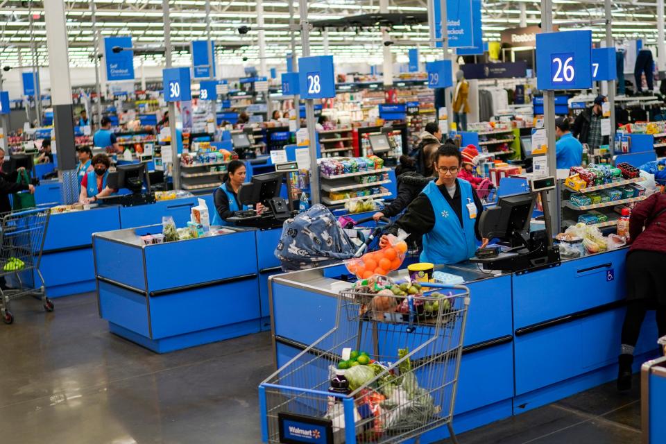 Cashiers process purchases at a Walmart Supercenter in North Bergen, N.J., on Thursday, Feb. 9, 2023. On Tuesday, the Labor Department reports on U.S. consumer prices for January. The consumer price index is closely watched by the Federal Reserve, which has raised interest rates eight times in the past year in an attempt to cool the economy and bring down inflation. (AP Photo/Eduardo Munoz Alvarez)