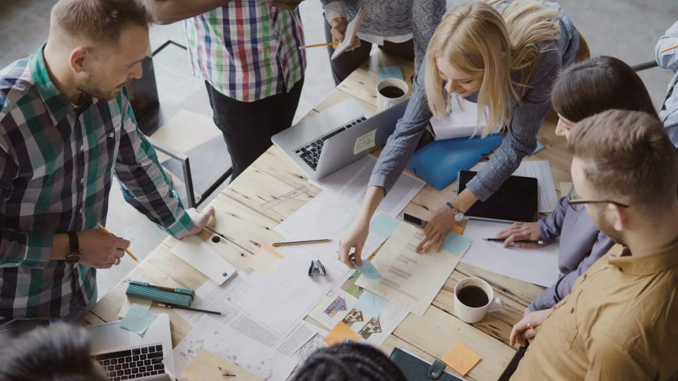 people working at table in office