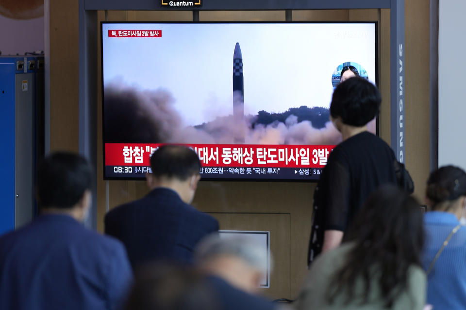 People watch a TV screen showing a news program reporting about North Korea's missile launch with file footage, at a train station in Seoul, South Korea, Wednesday, May 25, 2022. North Korea launched three ballistic missiles toward the sea on Wednesday, its neighbors said, hours after President Joe Biden wrapped up his trip to Asia where he reaffirmed U.S. commitment to defend its allies in the face of the North's growing nuclear threat. (AP Photo/Lee Jin-man)