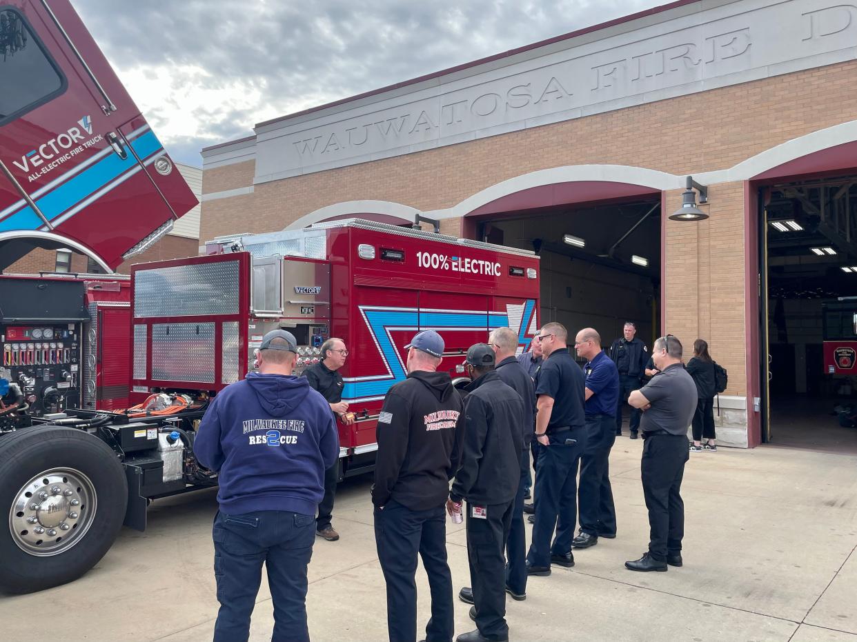 Firefighters from departments around Milwaukee check out the Vector, Brookfield manufacturer REV Group's fire engine that runs completely on electric power, Wednesday, Oct. 18, at the Wauwatosa Fire Department.