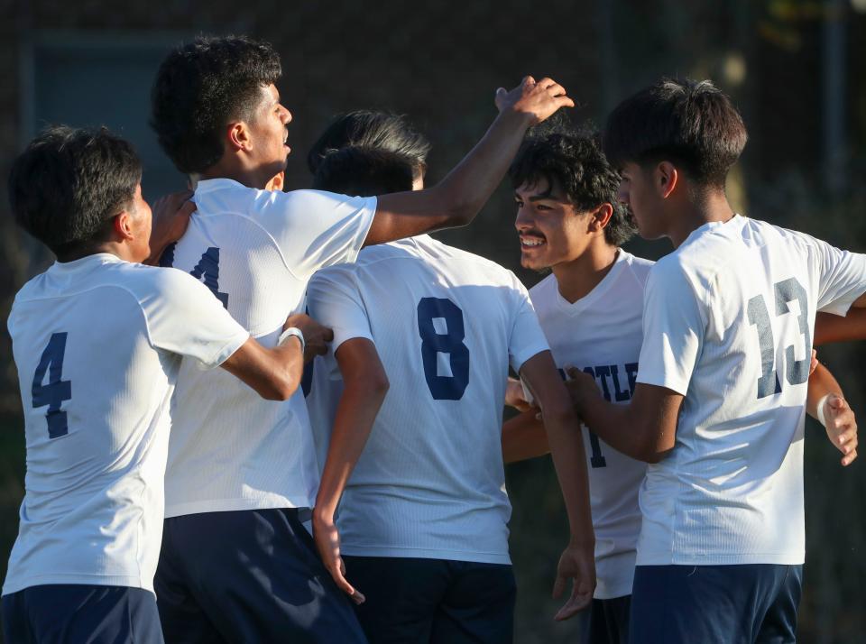 Delcastle's Cristofer Torres Romero (second from right) celebrates his overtime goal with his Cougar teammates in Delcastle's 1-0 win over Newark on Oct. 3.