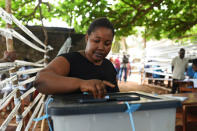 A woman casts her vote at a polling station during a presidential run-off in Freetown, Sierra Leone March 31, 2018. REUTERS/Olivia Acland