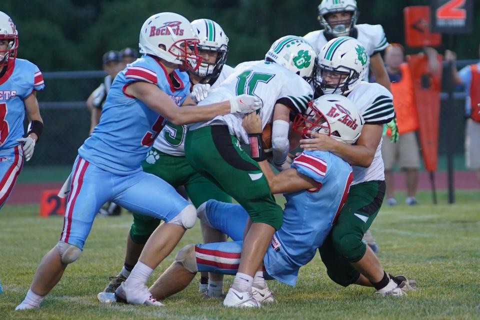 Ridgedale's Nathan Thiel and a teammate make a tackle during the Franklin Furnace Green game earlier this season. The Rockets down the road to fellow Marion County squad Elgin Friday night in a league football game.