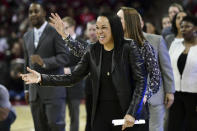 FILE - In this Feb. 17, 2020, file photo, South Carolina coach Dawn Staley laughs before an NCAA college basketball game against Vanderbilt in Columbia, S.C. Dawn Staley helped guide South Carolina to No. 1 and earned coach of the year honors for the first time. The veteran Gamecocks coach was announced as The Associated Press women's basketball coach of the year Monday, March 23, 2020. (AP Photo/Sean Rayford, File)