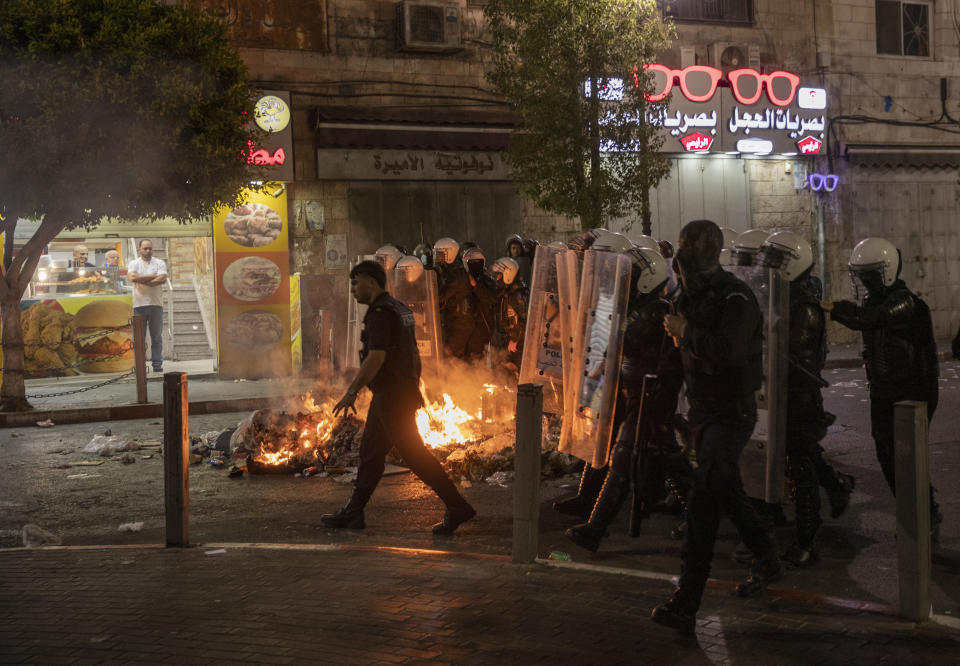 Angry demonstrators set fires, block the streets of the city center and clash with riot police following the death of Nizar Banat, an outspoken critic of the Palestinian Authority, in the West Bank city of Ramallah, Thursday, June 24, 2021. Banat who was a candidate in parliamentary elections called off earlier this year died after Palestinian security forces arrested him and beat him with batons on Thursday, his family said. (AP Photo/Nasser Nasser)