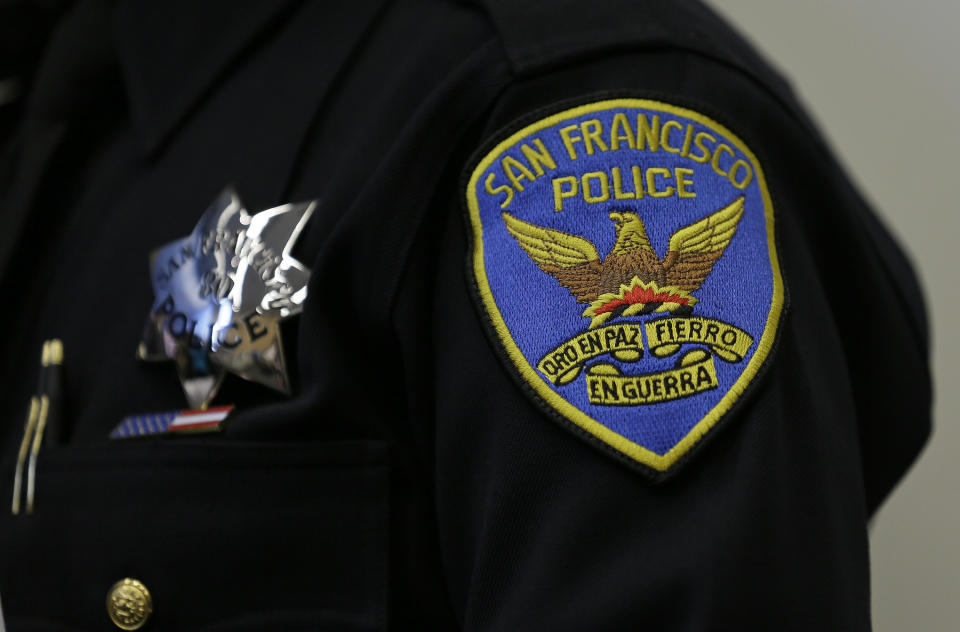 FILE -This April 29, 2016, file photo, shows a patch and badge on the uniform of a San Francisco police officer in San Francisco. The San Francisco Police Department will stop releasing mugshots of people arrested unless they pose a threat in an effort to stop perpetuating racial stereotypes, the police chief announced Wednesday, July 1, 2020. (AP Photo/Eric Risberg, File)