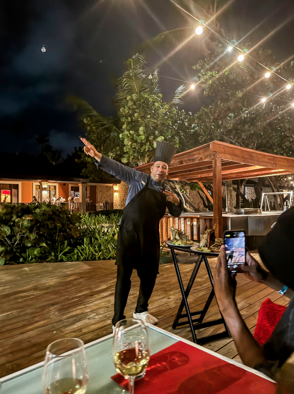 a man standing on a table with his arms up