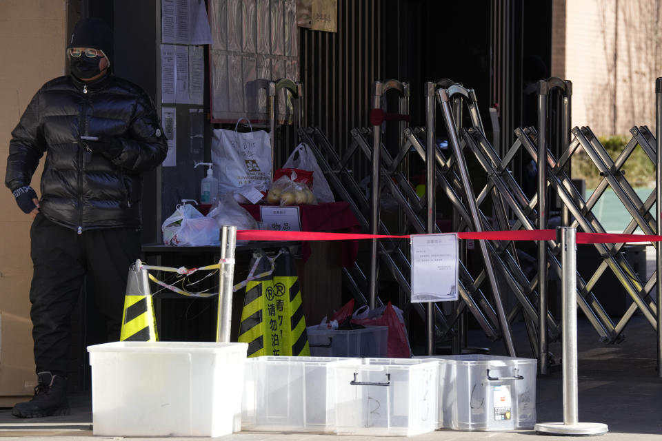 A man walks past deliveries left outside an old folks home in Beijing, Friday, Dec. 16, 2022. A week after China dramatically eased some of the world's strictest COVID-19 containment measures, uncertainty remained Thursday over the direction of the pandemic in the world's most populous nation. (AP Photo/Ng Han Guan)