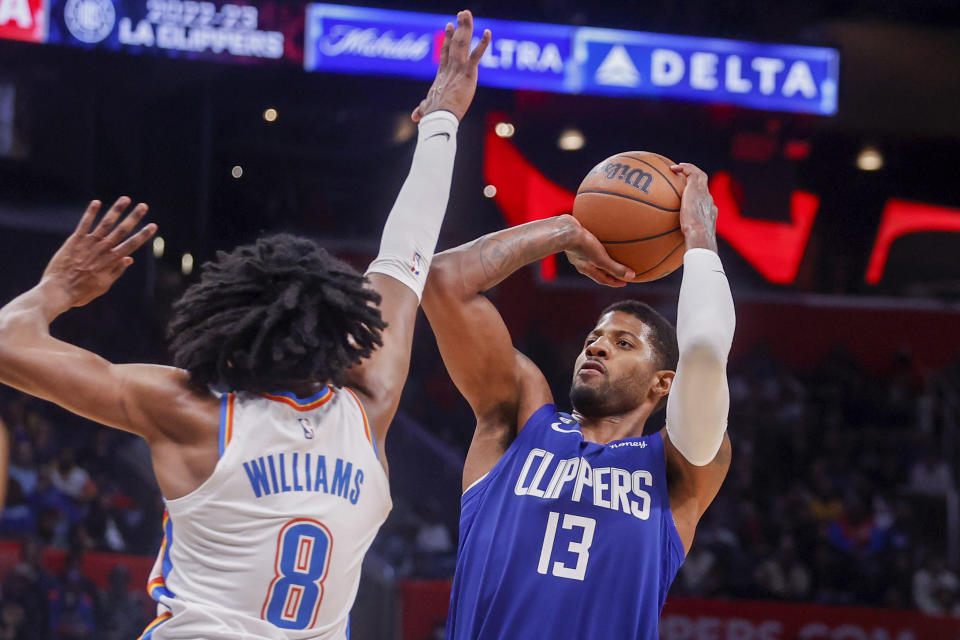 Los Angeles Clippers forward Paul George (13) shoots against Oklahoma City Thunder guard Jalen Williams (8) during the second half of an NBA basketball game Tuesday, March 21, 2023, in Los Angeles. (AP Photo/Ringo H.W. Chiu)