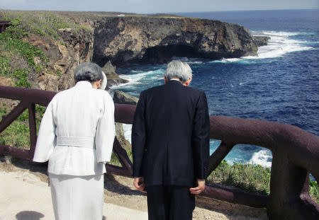 FILE PHOTO: Japan's Emperor Akihito (R) and Empress Michiko bow in silent prayer at Banzai Cliff, or Puntan Sabaneta, to pay tribute to the Japanese soldiers and civilians who jumped off the rocky cliff 61 years ago rather than surrender to U.S forces in the bloody World War Two Battle of Saipan in Saipan June 28, 2005. REUTERS/Eriko Sugita/U.S. POOL/File Photo