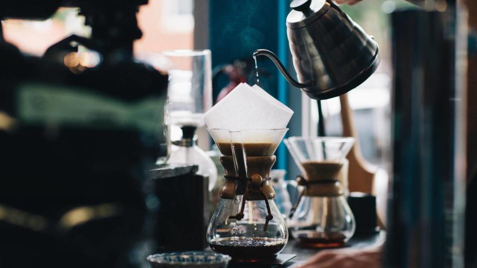 Person making filter coffee in a cafe