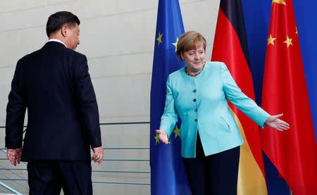 German Chancellor Angela Merkel and Chinese President Xi Jinping are seen after the news conference at the Chancellery in Berlin, Germany, July 5, 2017. REUTERS/Fabrizio Bensch