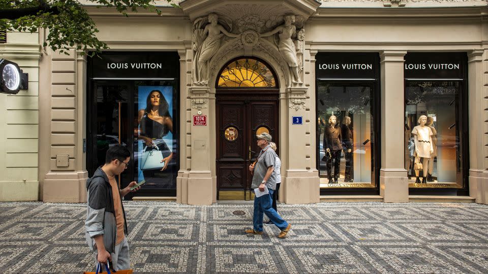 Pedestrians pass a Louis Vuitton luxury boutique on Parizska street in Prague, Czech Republic. - Milan Jaros/Bloomberg/Getty Images