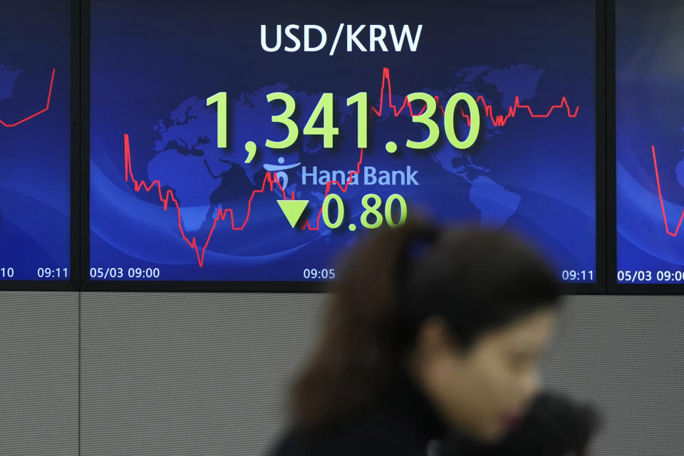 A currency trader works near the screen showing the foreign exchange rate between U.S. dollar and South Korean won at a foreign exchange dealing room in Seoul, South Korea, Wednesday, May 3, 2023. Asian shares declined Wednesday, tracking losses on Wall Street as shares of beleaguered banks tumbled again and worries about the economy deepened. (AP Photo/Lee Jin-man)