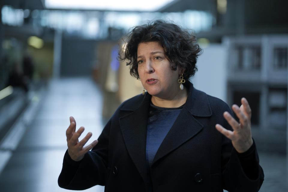 Ruth Ur, the curator and the director of the German Friends of Yad Vashem, talks to The Associated Press, inside the exhibition with items from Israel's Yad Vashem Holocaust memorial set in the main hall of the Paul-Loebe-Haus of the German parliament Bundestag in Berlin, Germany, Monday, Jan. 23, 2023. An exhibition marking the 70th anniversary of Israel's Yad Vashem Holocaust memorial brings back to Germany a diverse set of everyday objects that Jews took with them when they fled the Nazis. (AP Photo/Markus Schreiber)