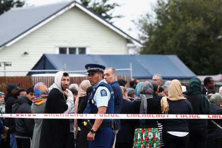 Members of Muslim religious groups gather for prayers outside the Linwood Mosque in Christchurch, New Zealand March 18, 2019. REUTERS/Edgar Su