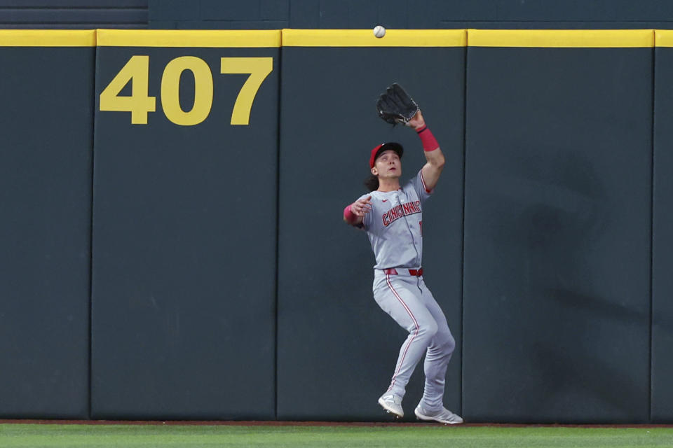 Cincinnati Reds center fielder Stuart Fairchild catches a deep fly ball by Texas Rangers' Marcus Semien during the fifth inning of a baseball game Friday, April 26, 2024, in Arlington, Texas. (AP Photo/Richard W. Rodriguez)