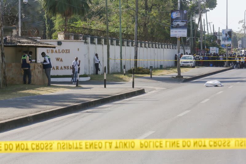 The slain body of an attacker who was wielding an assault rifle is seen in a body bag outside the French embassy in the Salenda area of Dar es Salaam