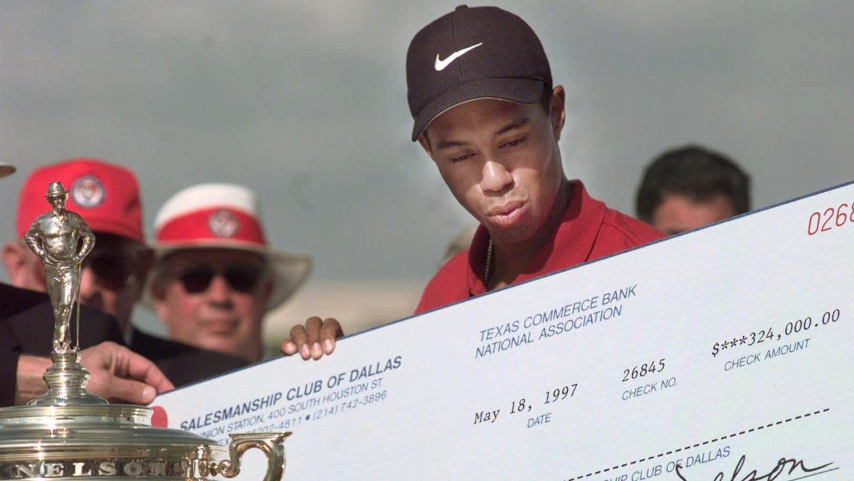 Mandatory Credit: Photo by Lm Otero/AP/Shutterstock (6510202a)WOODS Tiger Woods reacts when handed a check for $324,000 after winning the GTE Byron Nelson Classic tournament in Irving, Texas, .