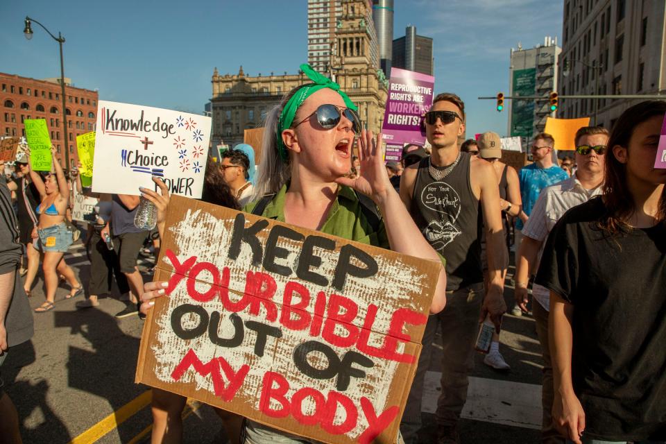 Abortion-rights protesters march through downtown Detroit following a rally at the Theodore Levin Federal Court building in Detroit to protest against the U.S. Supreme Court decision to overturn Roe v. Wade on June 24, 2022. If voters adopt Proposal 3 in the Nov. 8, 2022 election, it would add an explicit right to seek abortions in the Michigan Constitution.