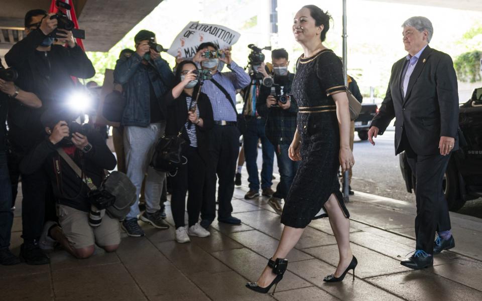 Meng Wanzhou walks past the media upon arriving at BC Supreme Court for her hearing on May 27, 2020 in Vancouver - Rich Lam /Getty Images 