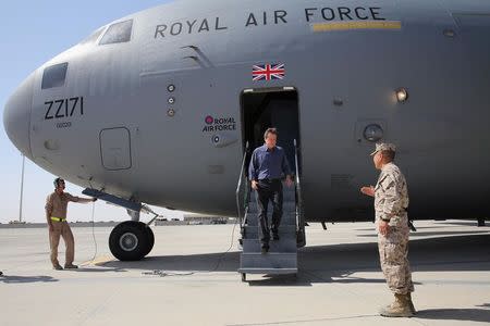 Britain's Prime Minister David Cameron is greeted on arrival at Camp Bastion in southern Afghanistan, October 3, 2014. REUTERS/Pool/Dan Kitwoood