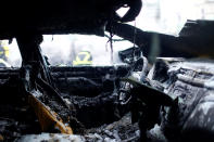 <p>The interior of a burnt down car is seen as firefighters work in the background during the G20 summit in Hamburg, Germany, July 7, 2017. (Photo: Hannibal Hanschke/Reuters) </p>