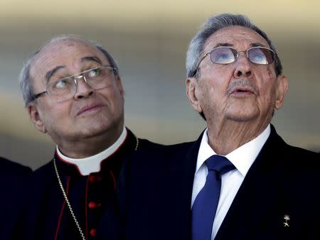 Cuba's President Raul Casto (R) and Cuba's Cardinal Jaime Ortega, leader of Cuba's Catholic Church look at the airplane of Pope Francis at Jose Marti airport in Havana in this February 12, 2016 file picture. REUTERS/Enrique de la Osa/Files