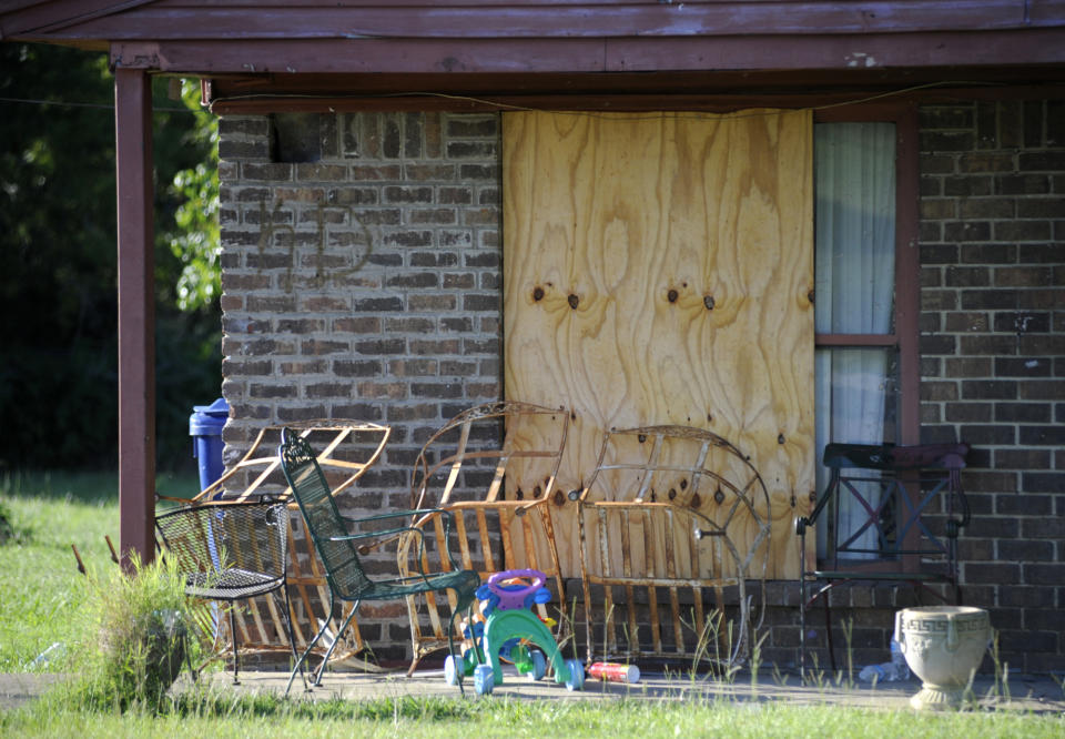 Plywood covers the window of a damaged home, Wednesday, July 27, 2022, nearly four months after a small tornado shattered Branch Heights, a rural housing community in Eutaw, Ala. Some worry the continuing recovery shows how hard it may be to get over a big storm as the heart of hurricane season approaches the U.S. Gulf Coast. (AP Photo/Jay Reeves)