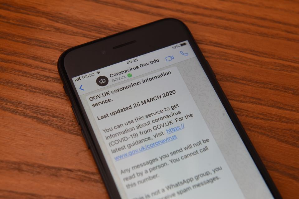 A posed picture taken in Marsden on March 25, 2020 shows a communication from the British government's Coronavirus Information Service on WhatsApp displayed on a smartphone. - Britain on March 24 said it will open a 4,000-bed field hospital at a London exhibition centre to treat coronavirus cases in the latest measure to tackle the outbreak after the government ordered a nationwide lockdown. The British health secretary told a news conference the temporary hospital, to be known as the NHS Nightingale Hospital, would open at the ExCeL centre in east London with two wards each with a capacity for 2,000 people. (Photo by Oli SCARFF / AFP) (Photo by OLI SCARFF/AFP via Getty Images)