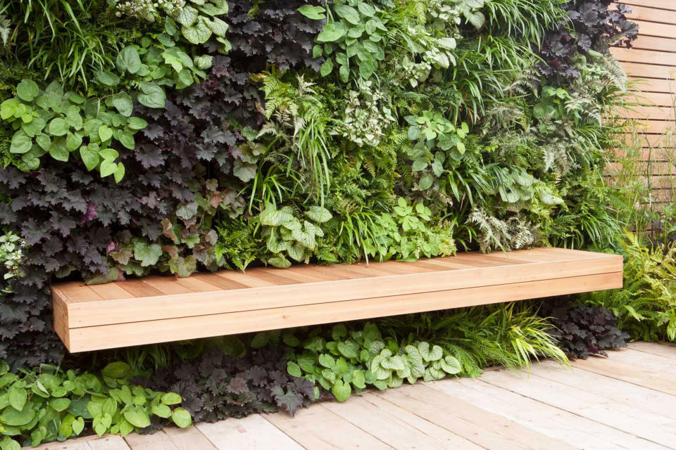 a living wall with a seat set into it