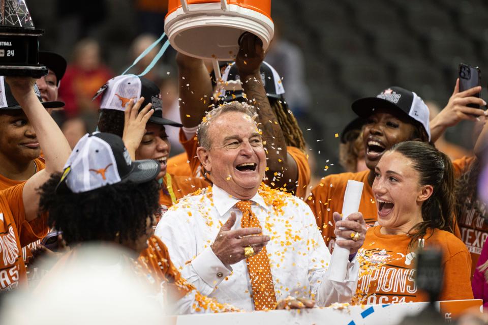 Texas women's basketball coach Vic Schaefer celebrates the Longhorns' win over Iowa State in the Big 12 Tournament championship game as his players dump confetti on him. Texas is in play for a possible No. 1 seed in the upcoming NCAA Tournament.