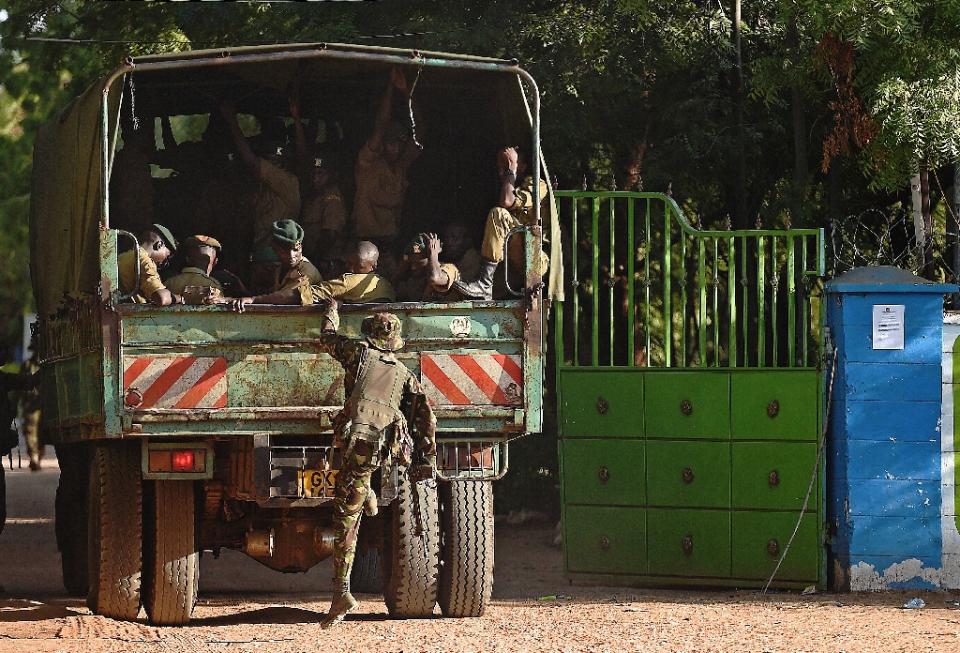 A member of Kenya Defence Forces boards a truck in Garissa on April 3, 2014 (AFP Photo/Carl de Souza)