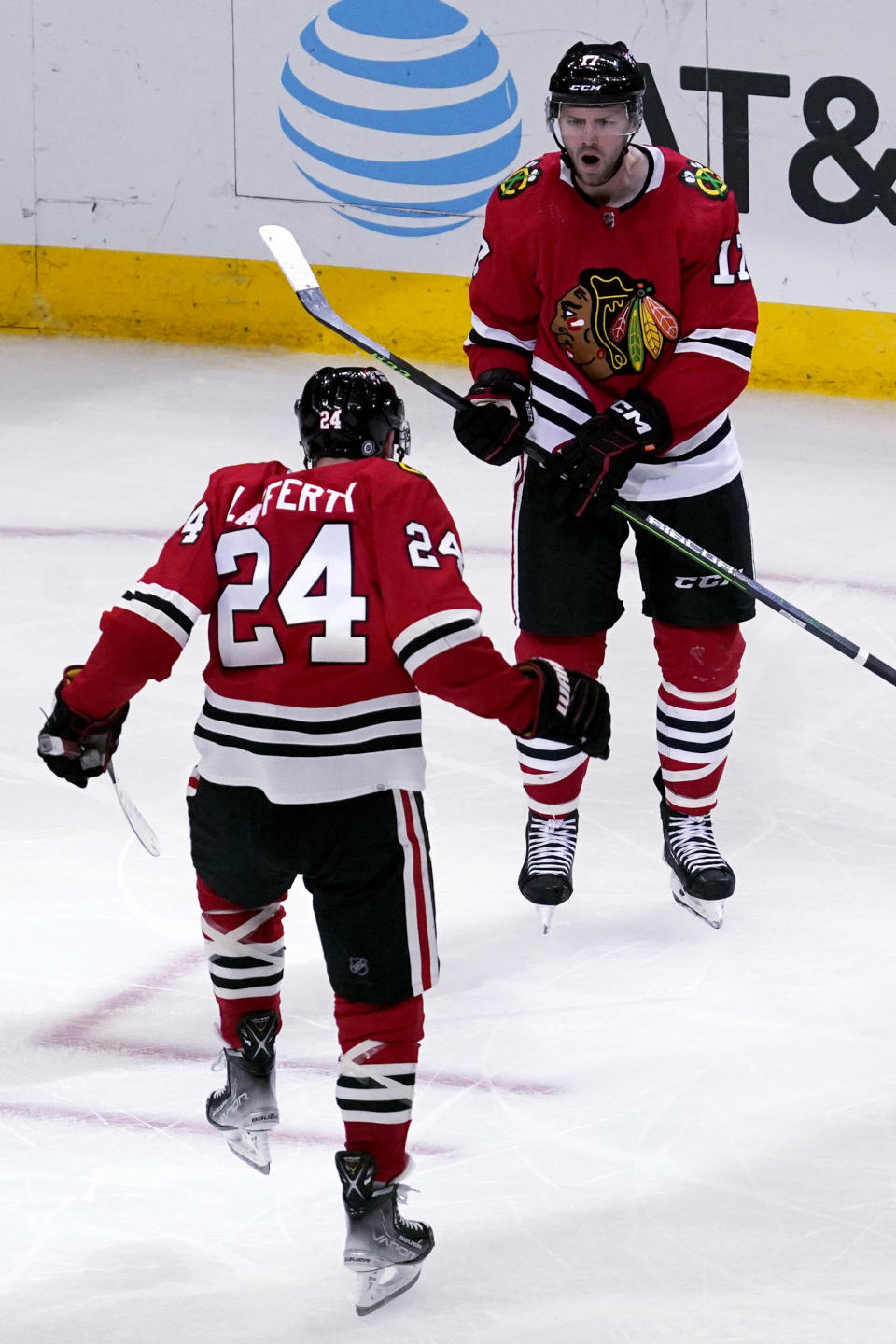 Chicago Blackhawks center Jason Dickinson, right, celebrates with center Sam Lafferty after scoring his goal during the third period of an NHL hockey game against the Seattle Kraken in Chicago, Sunday, Oct. 23, 2022. (AP Photo/Nam Y. Huh)