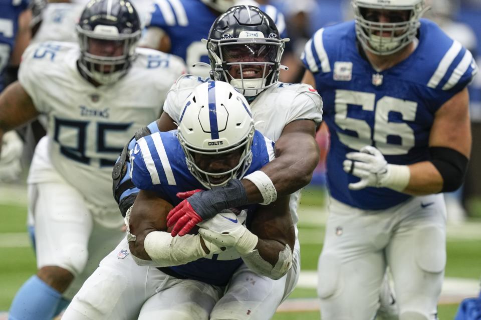 Indianapolis Colts running back Zack Moss, front, is tackled by Tennessee Titans linebacker <a class="link " href="https://sports.yahoo.com/nfl/players/32318" data-i13n="sec:content-canvas;subsec:anchor_text;elm:context_link" data-ylk="slk:Azeez Al-Shaair;sec:content-canvas;subsec:anchor_text;elm:context_link;itc:0">Azeez Al-Shaair</a>, behind, during the second half of an NFL football game, Sunday, Oct. 8, 2023, in Indianapolis. | Darron Cummings, Associated Press