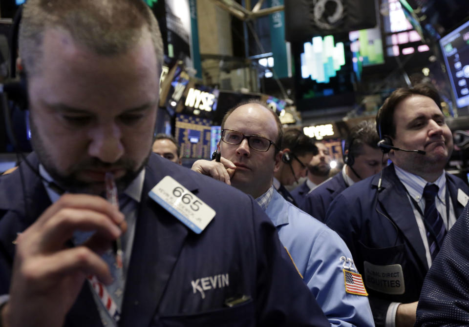 Traders work on the floor of the New York Stock Exchange, Friday, April 11, 2014. Weaker earnings at JPMorgan Chase are dragging bank stocks lower in early trading. Technology and biotech stocks also fell, a day after the worst rout for the Nasdaq composite index since 2011. (AP Photo/Richard Drew)